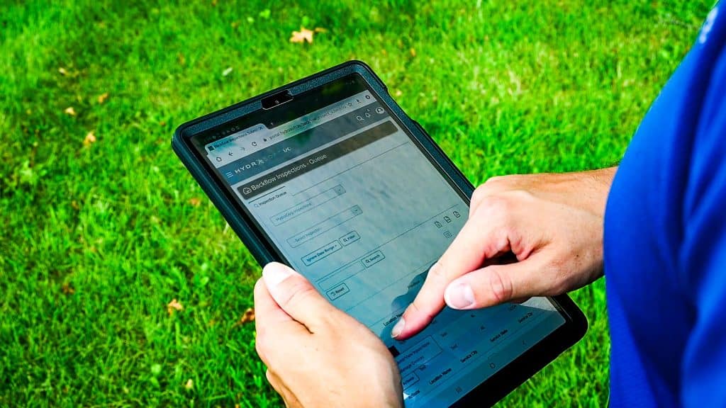 Inspector-with-Tablet---Exterior-1 - HydroCorp - Water Safety | Cross-Connection Control Programs - HydroCorp
