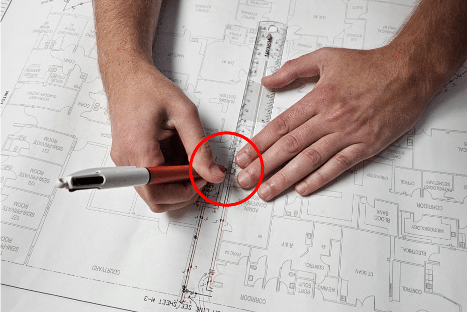 Hands-Drawing-on-Blueprints-with-Red-Callout-Circle - HydroCorp Hands-Drawing-on-Blueprints-with-Red-Callout-Circle - Poll Data Released on Hospital Piping Schematics - HydroCorp - HydroCorp
