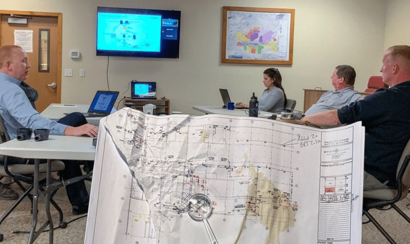 Old-cad-drawing-meeting-group - 10 Pains That Reliable Piping Schematics Address for Industrial Facilities - HydroCorp - HydroCorp
